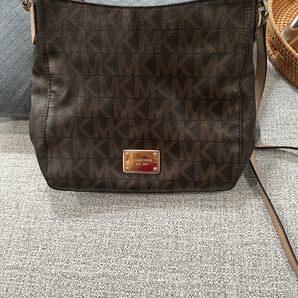 Michael Kors Crossbody purse, slight worn strap by the buckle.